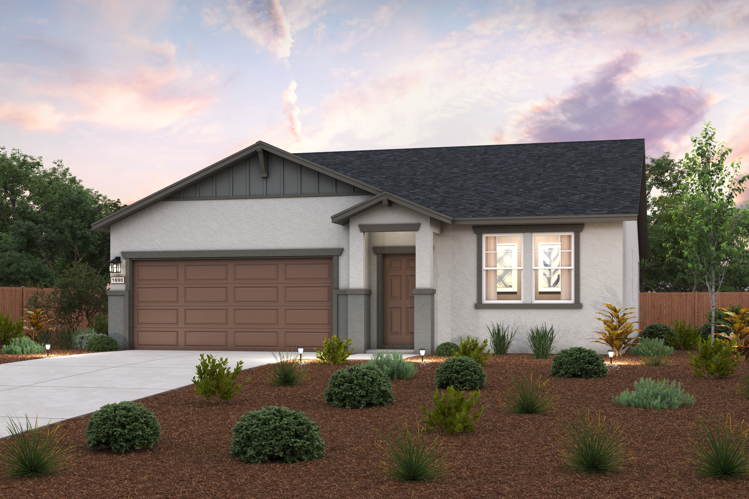 A house with a garage and bushes.