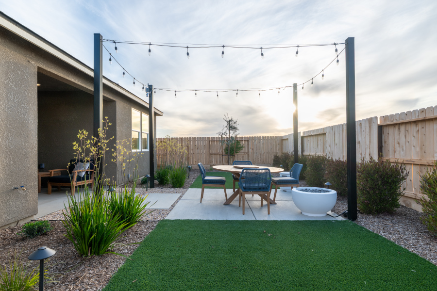 A backyard with a table and chairs.