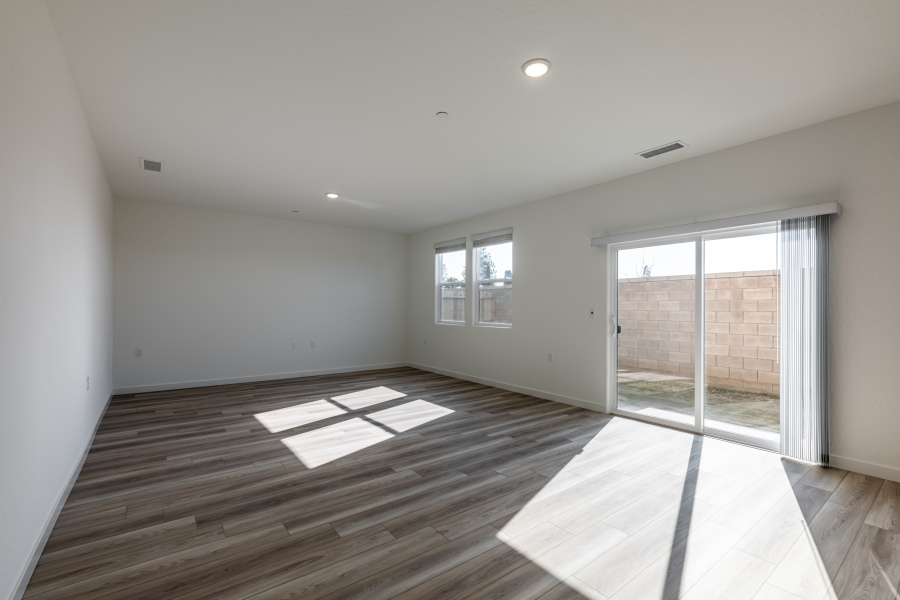 A room with a wood floor and windows.