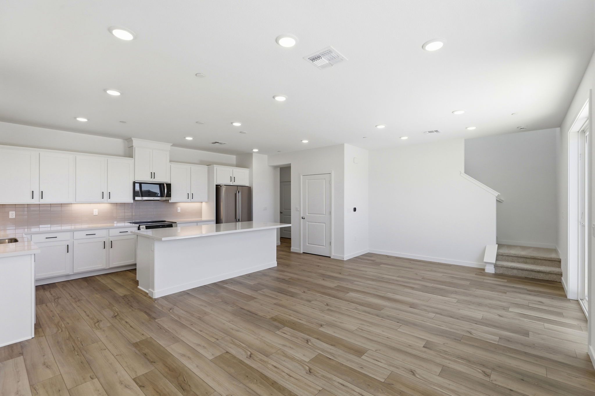 A large kitchen with white cabinets.