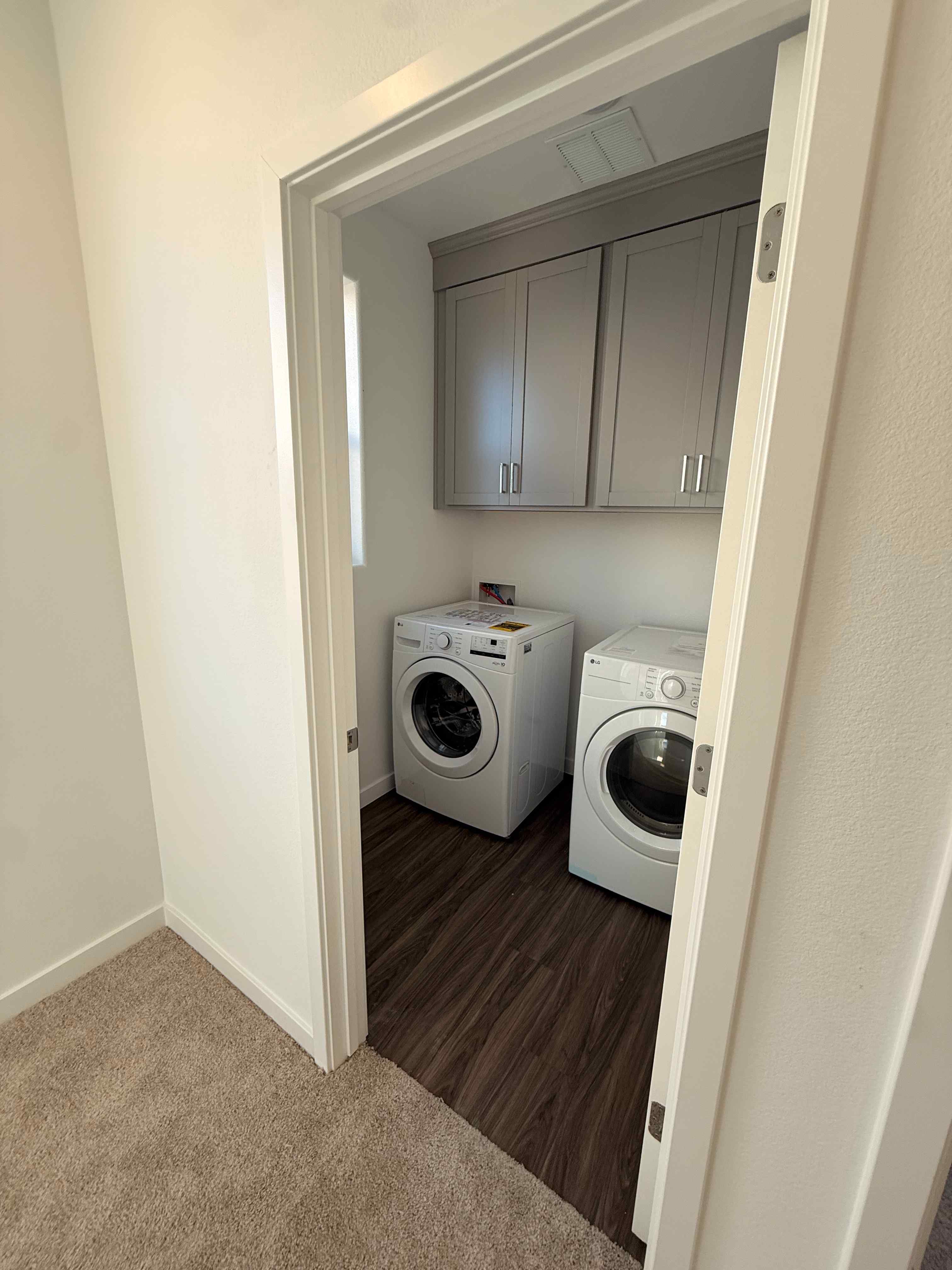 A washing machine and dryer in a room.