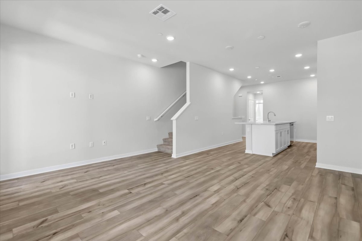 A room with a wood floor and white walls.