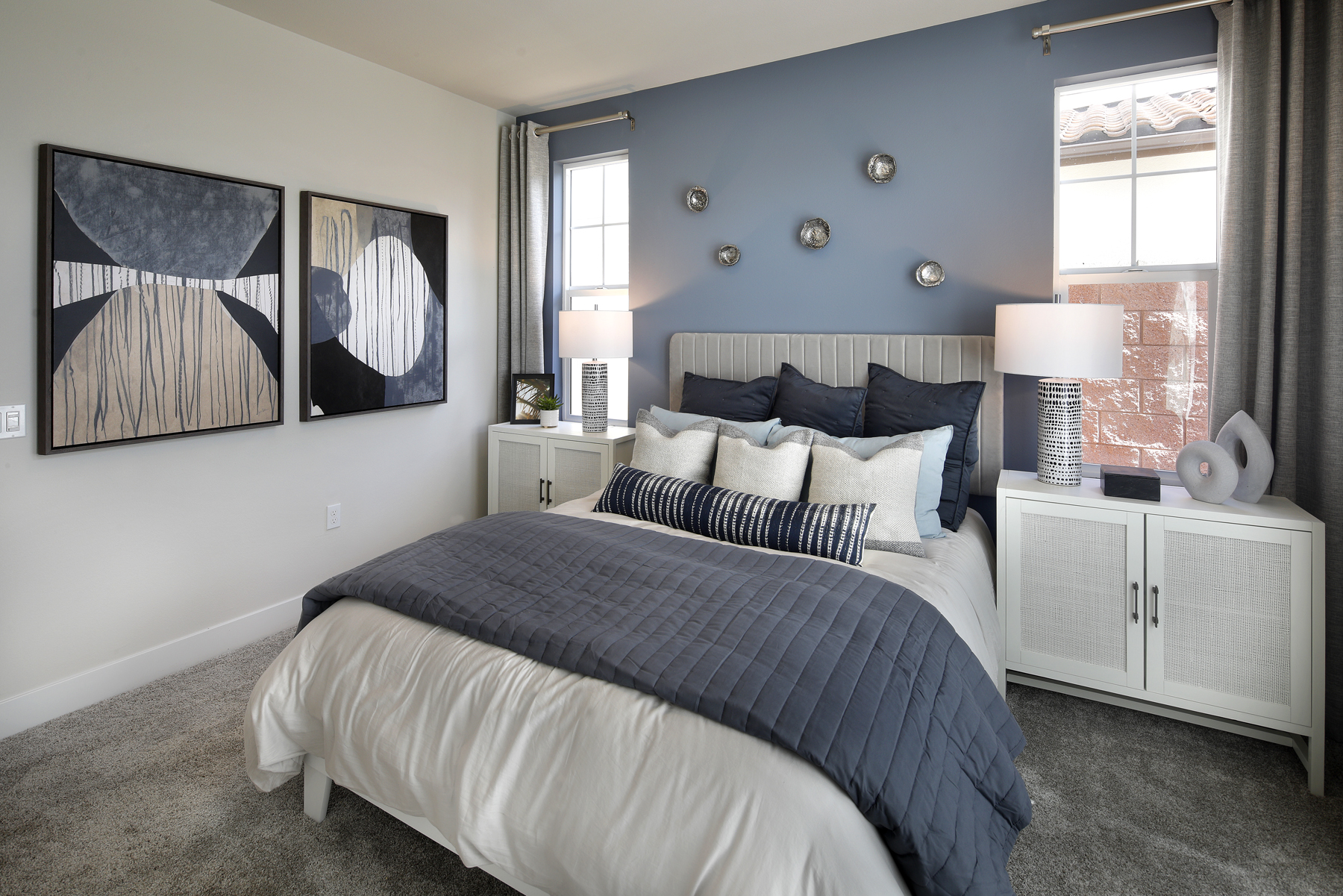 A bedroom with a bed and a lamp.