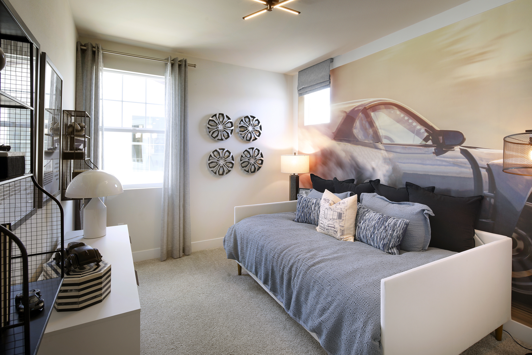 A bedroom with a bed and a lamp.