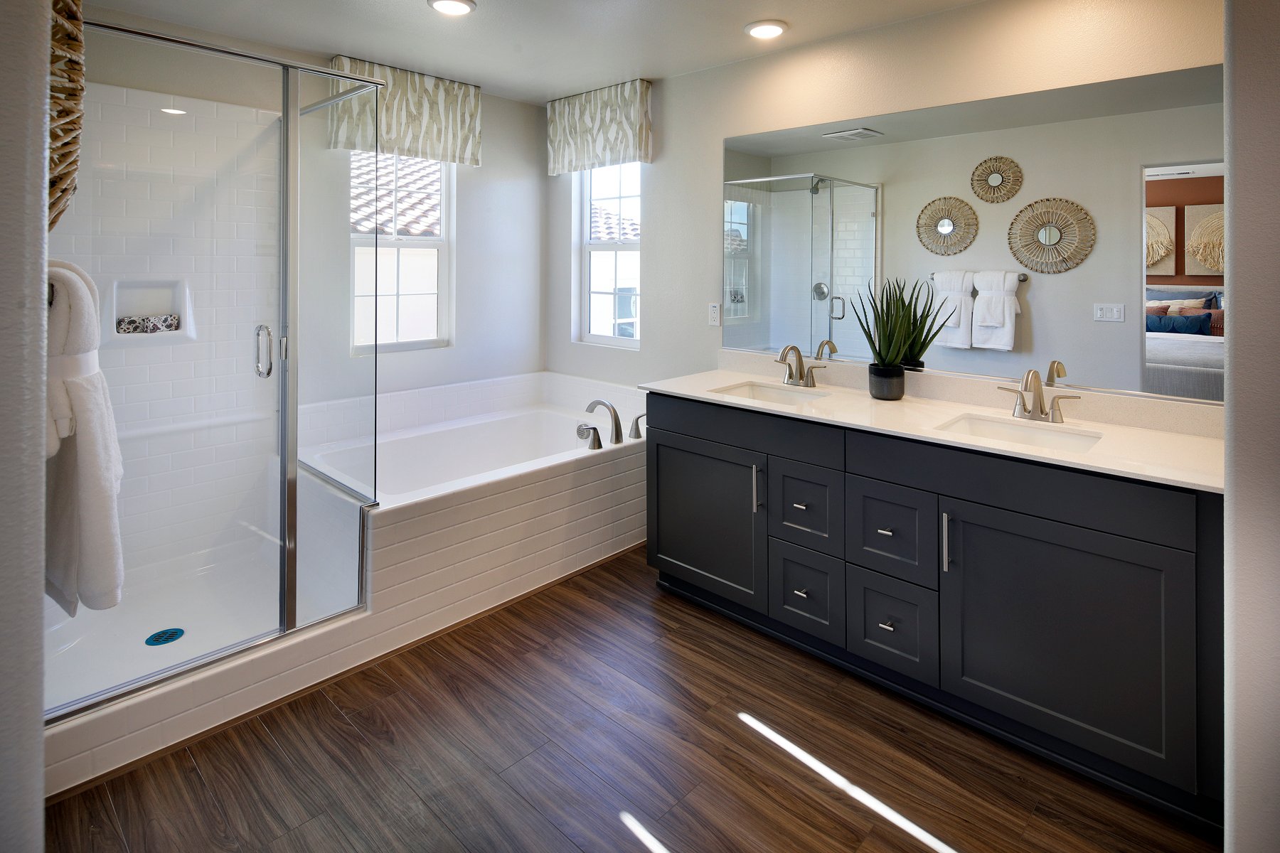 A bathroom with a tub sink and a shower.