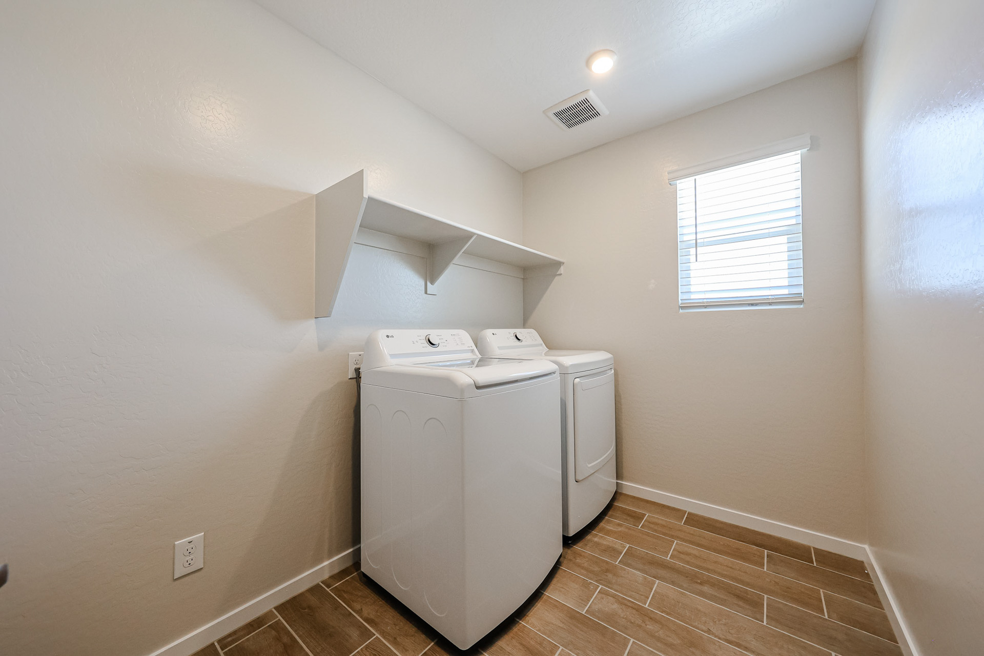 A room with a washing machine and a window.