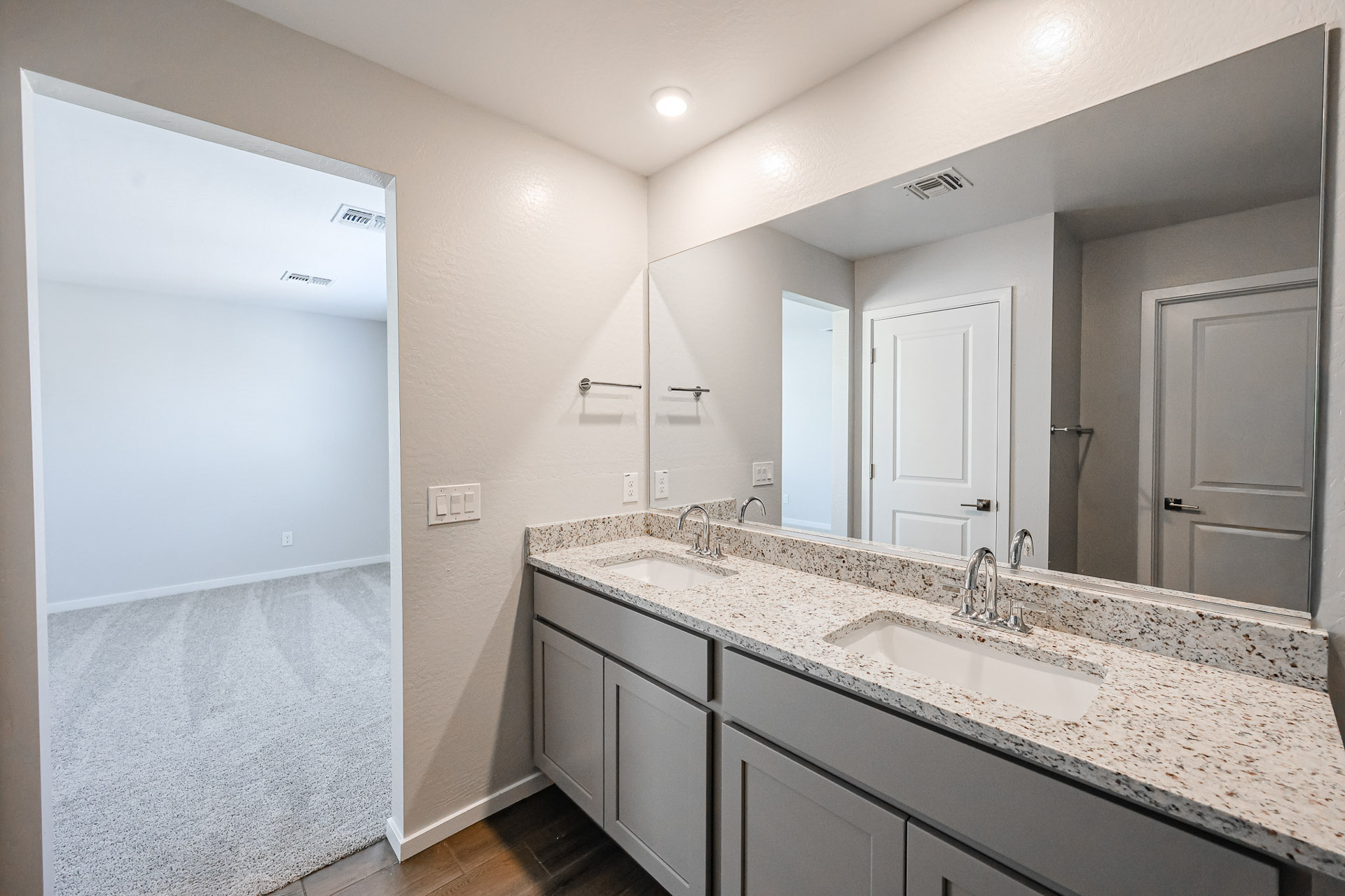 A bathroom with a large mirror.