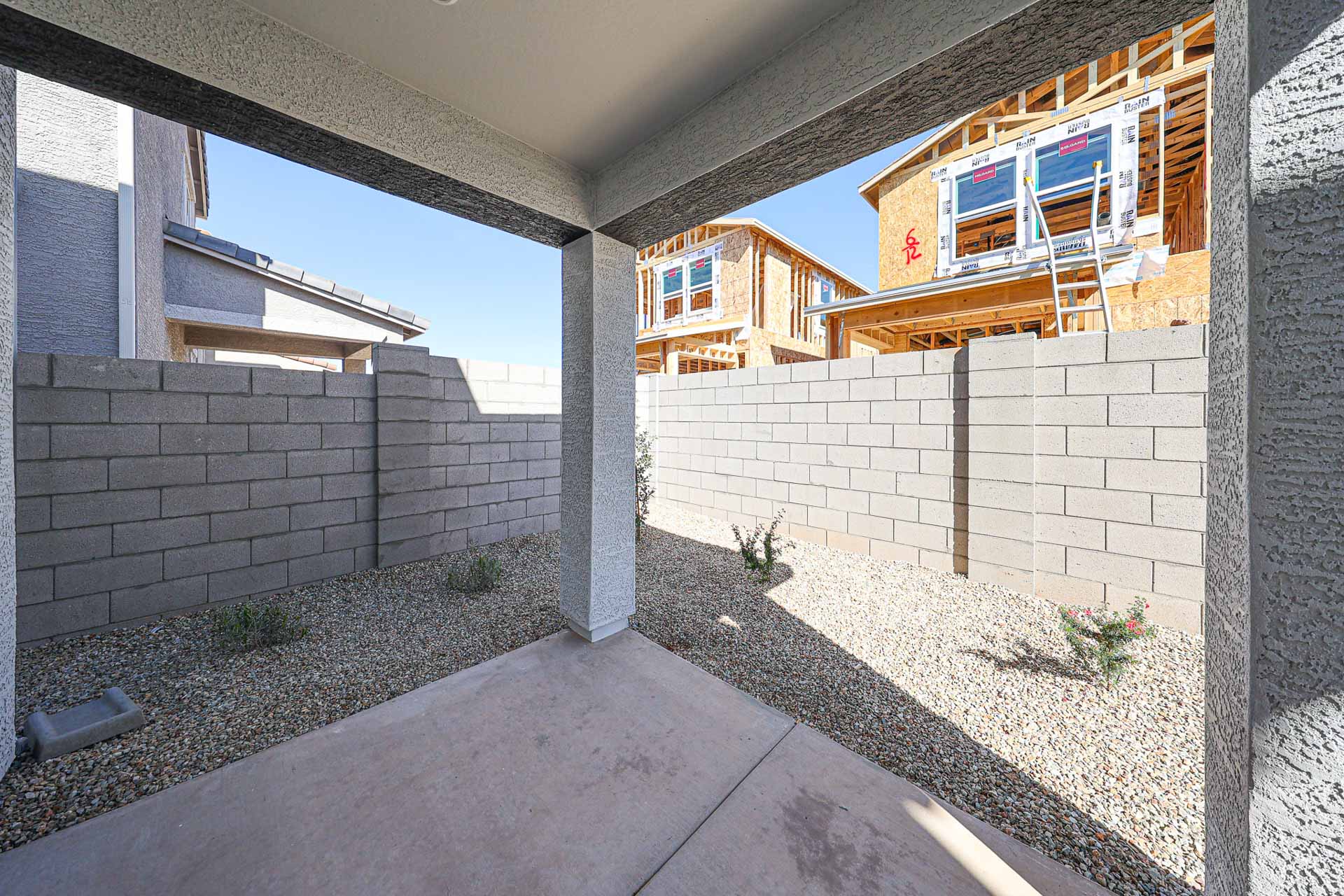 A brick wall with a ladder and a brick wall with a brick wall.