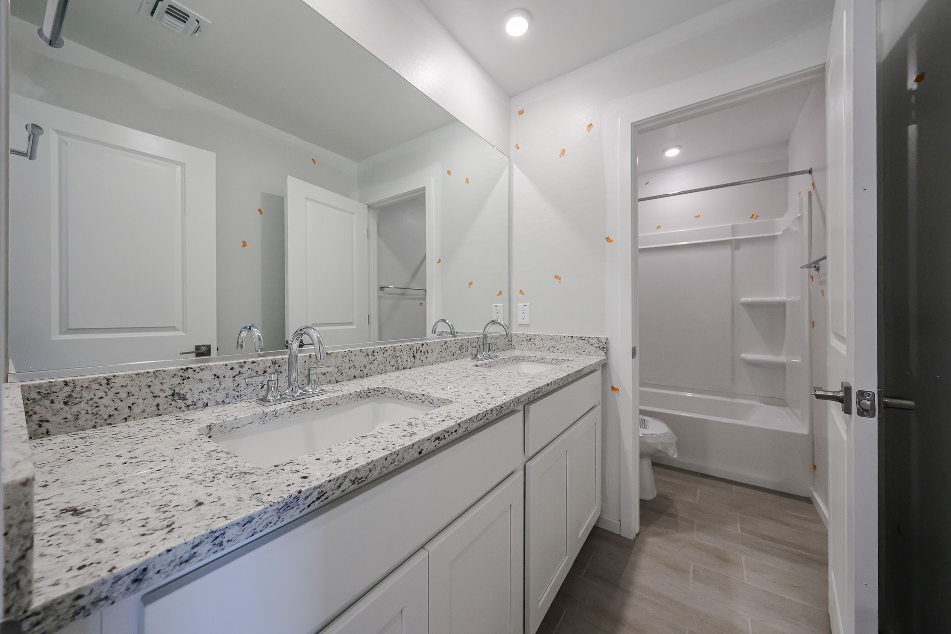 A bathroom with a marble countertop.