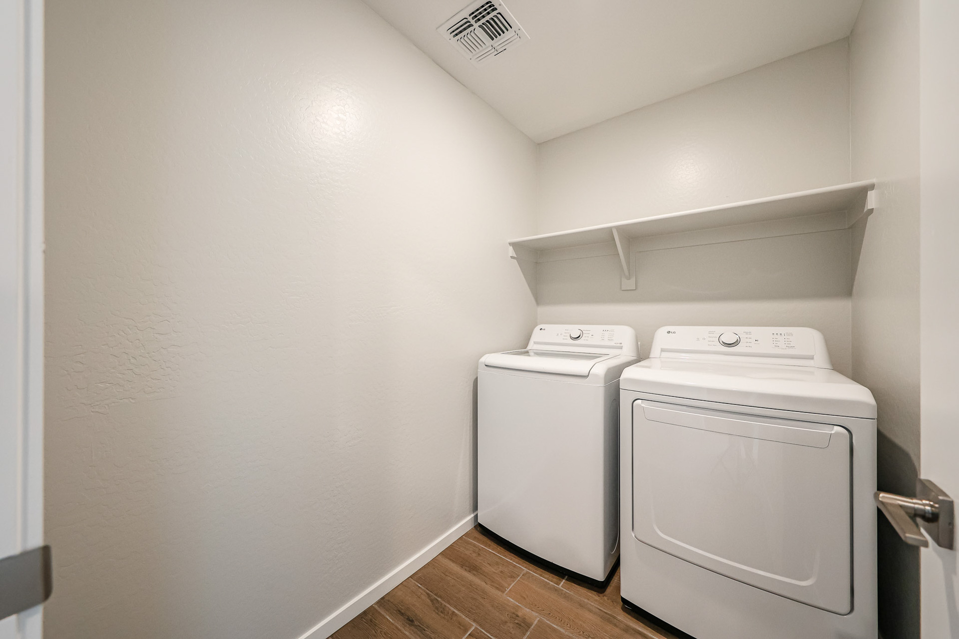 A washing machine in a room.
