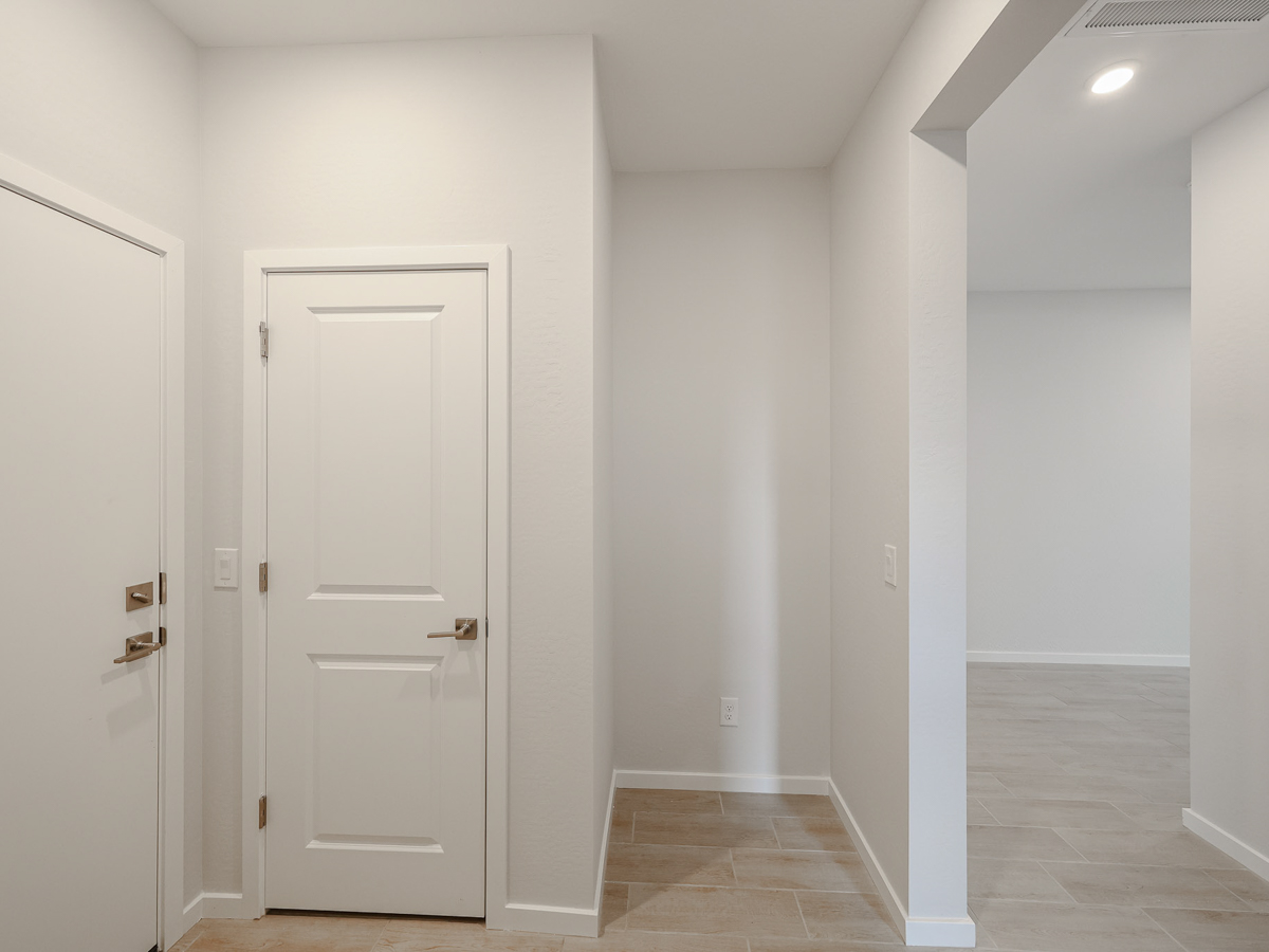 A hallway with white doors.