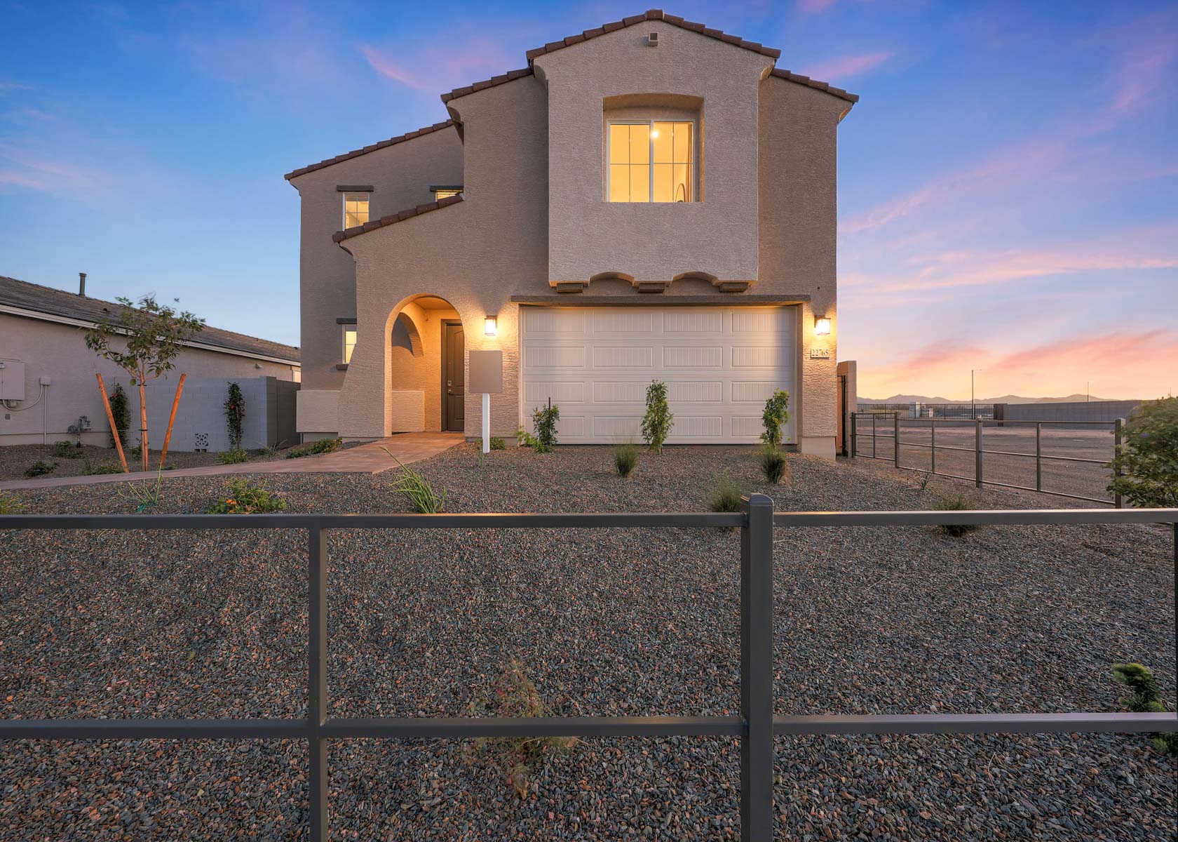 A house with a fence in front.