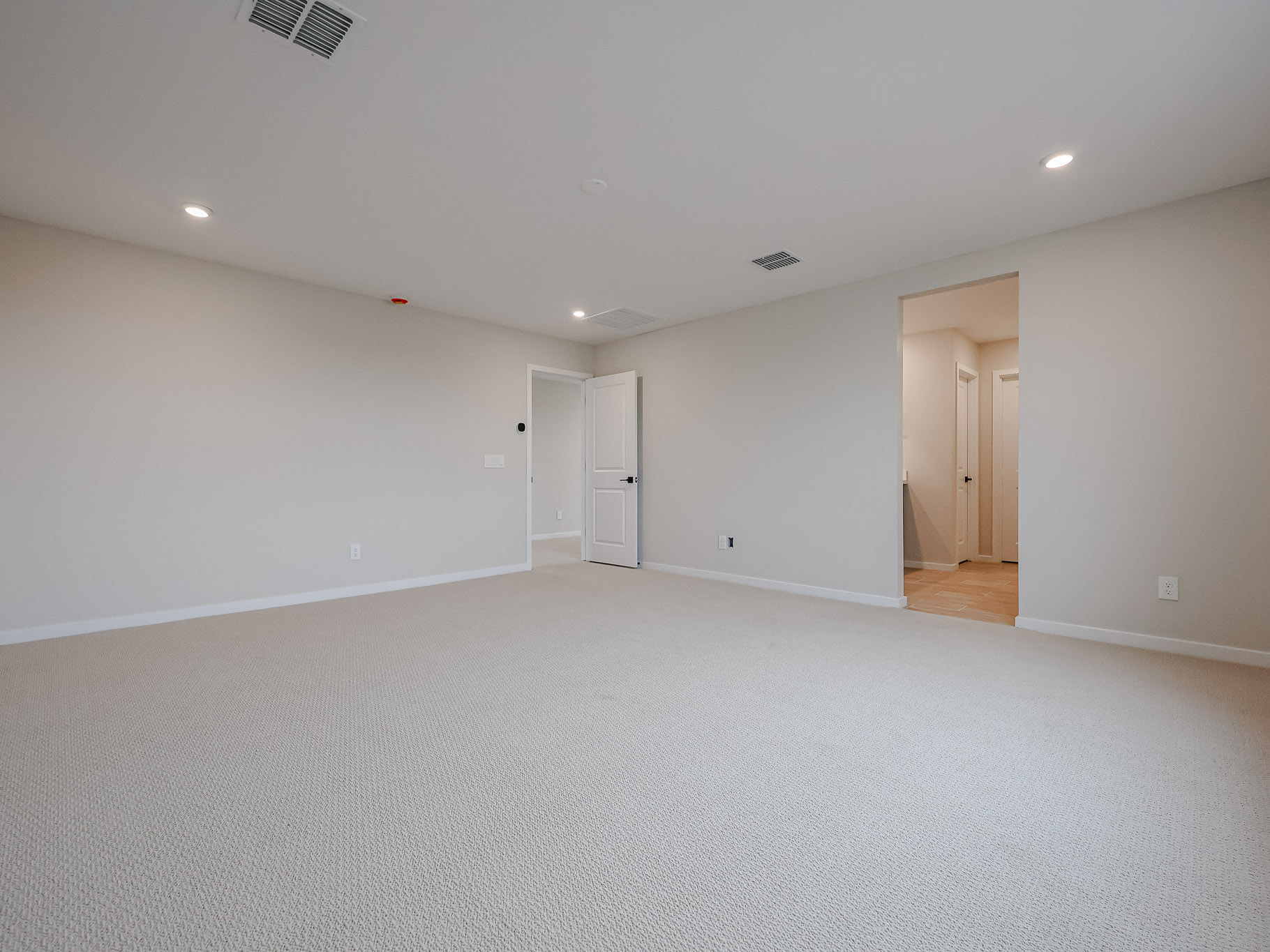 A room with white walls and doors.