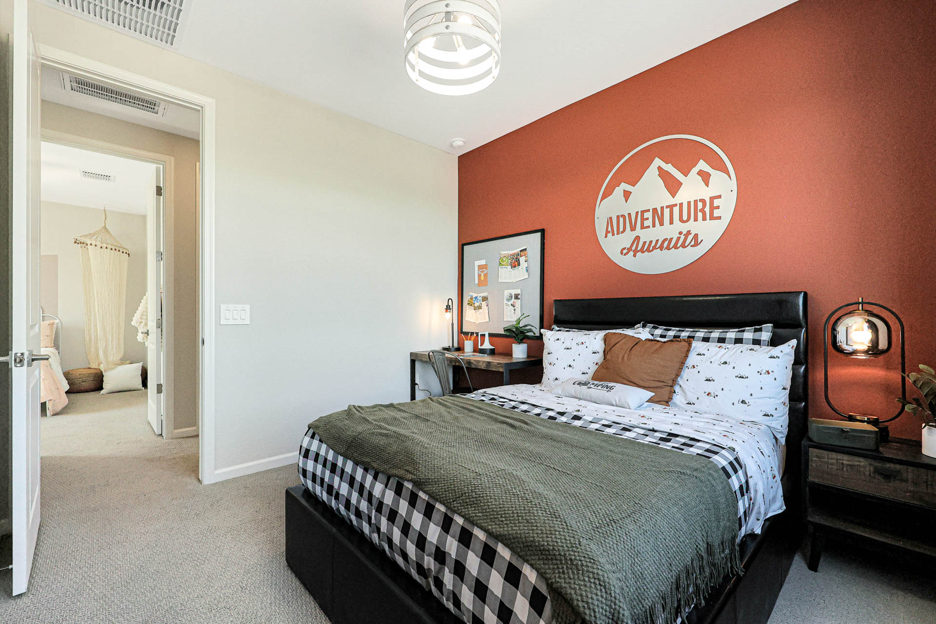 A bedroom with a bed and a lamp.