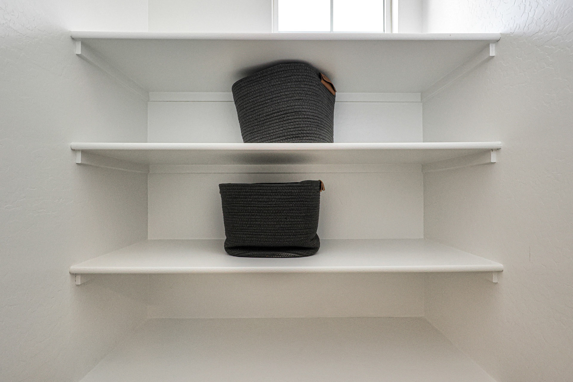 A shelf with a basket on it.