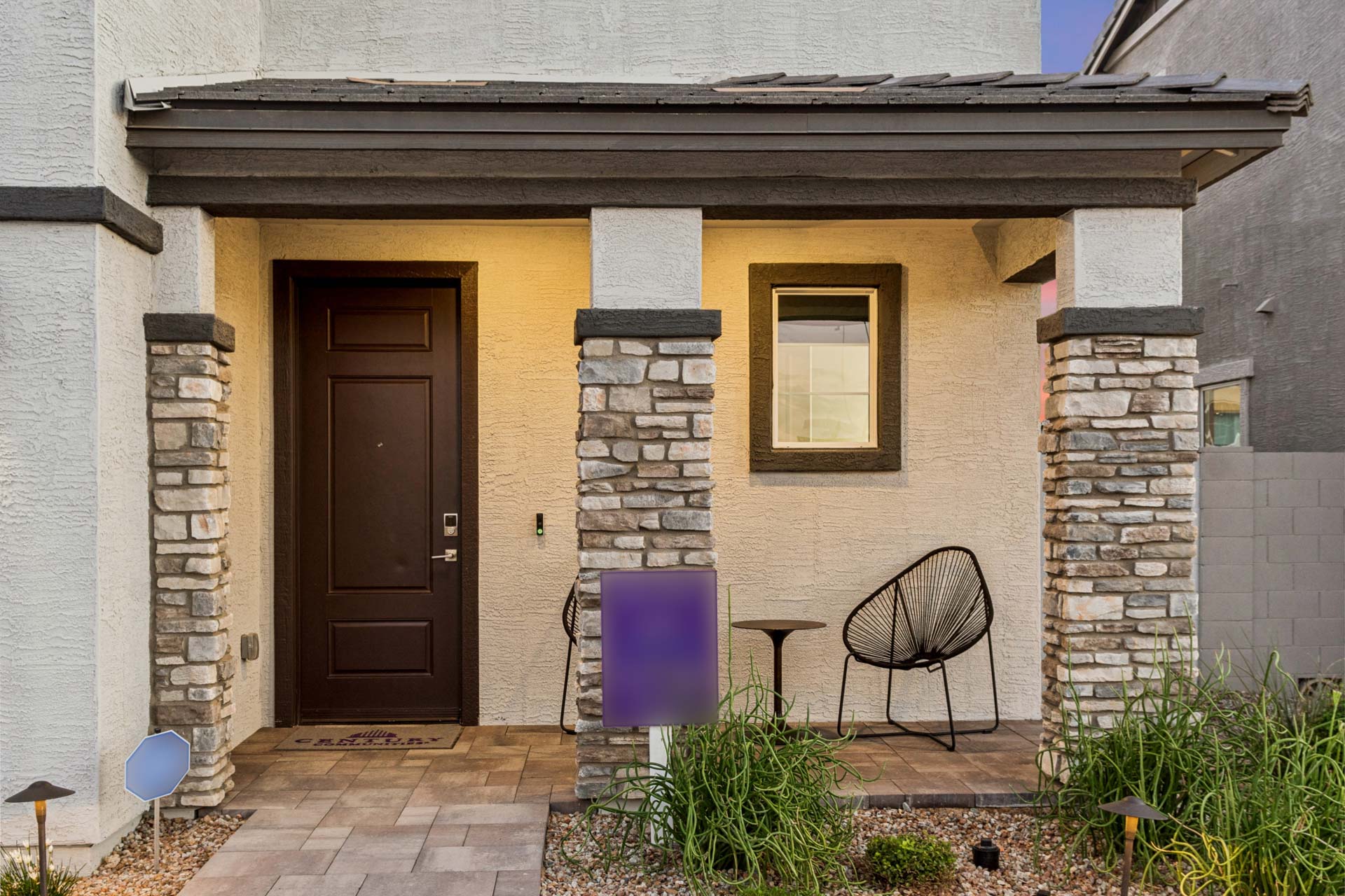 A house with a patio and chairs.