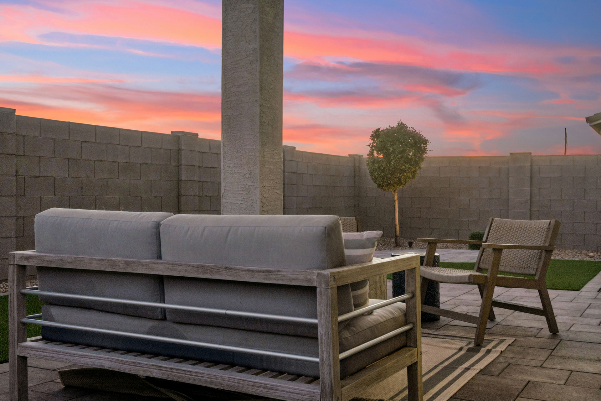 A couch and chairs outside.