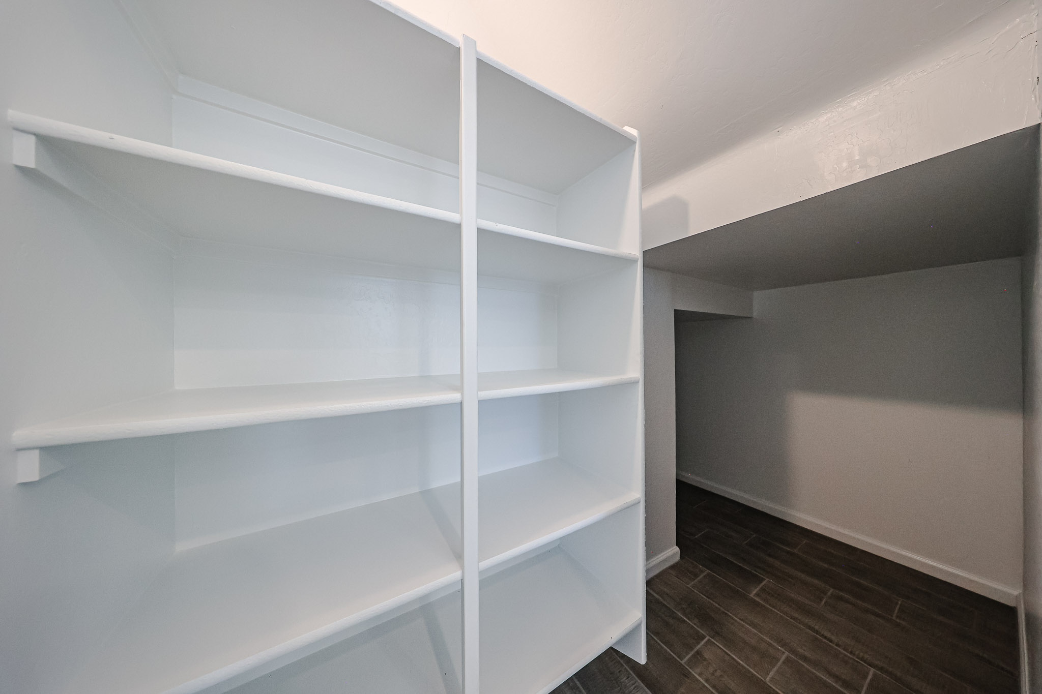 A white shelf in a room.
