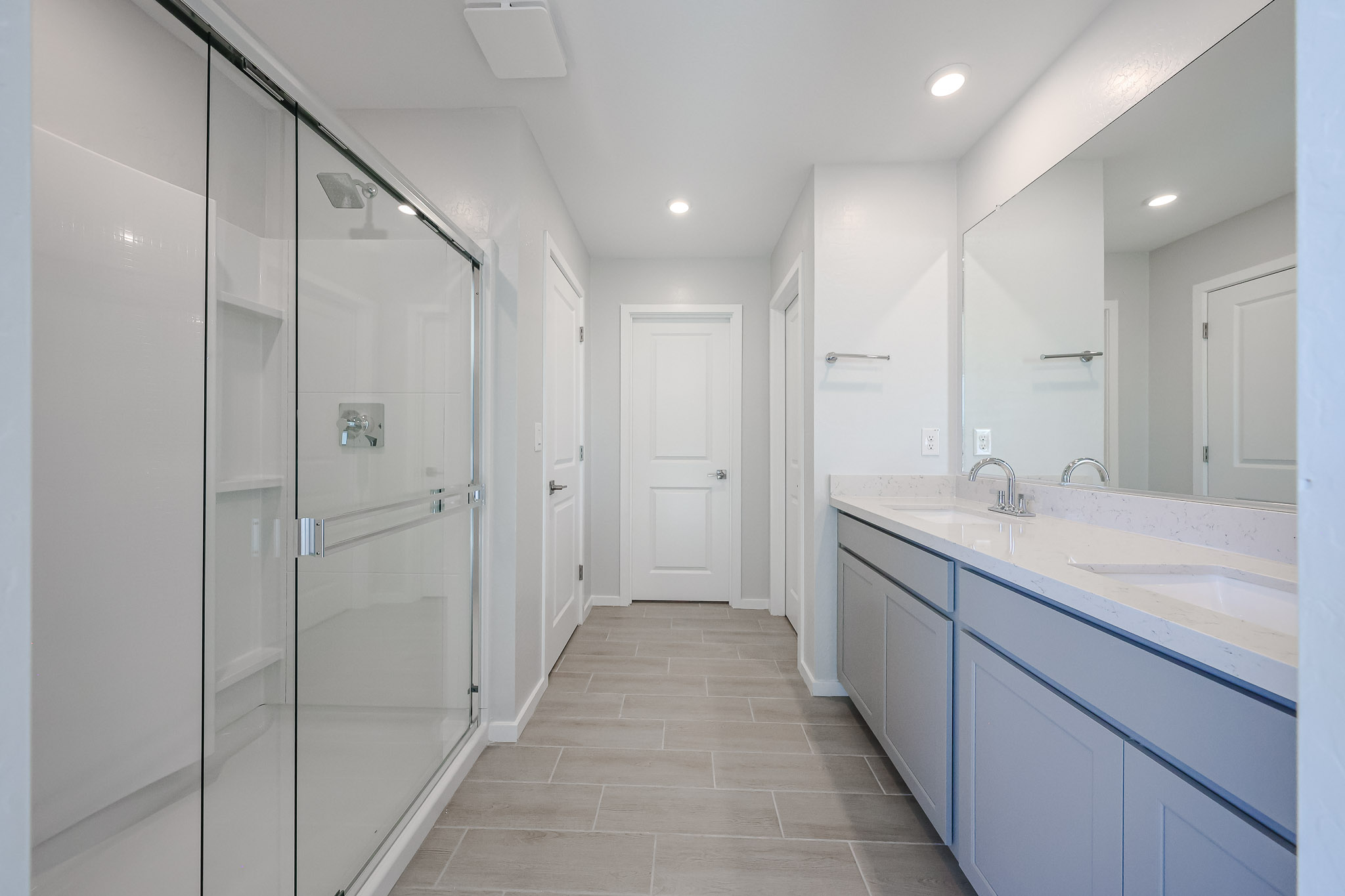 A bathroom with white cabinets.