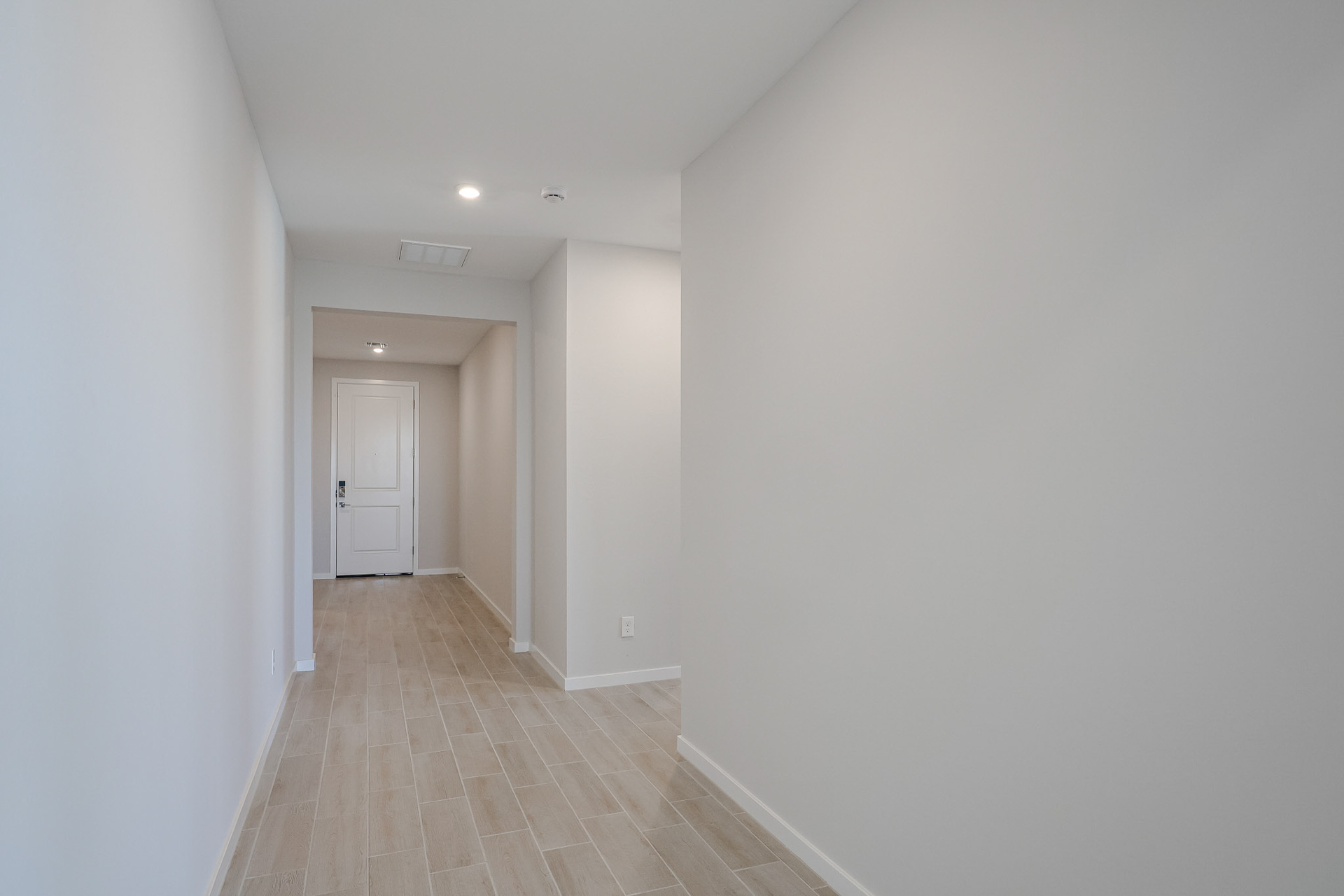A hallway with white walls.