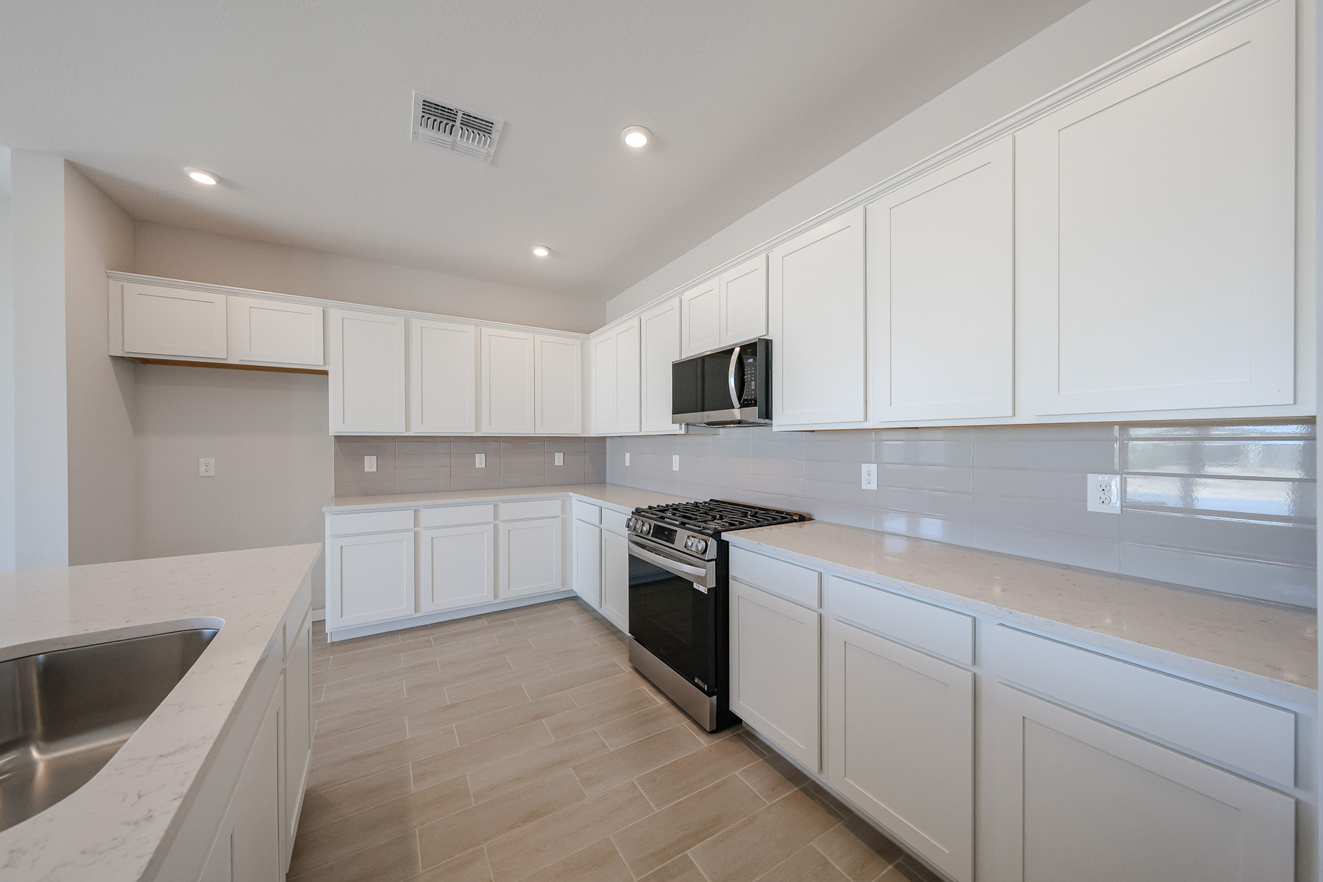 A kitchen with white cabinets.
