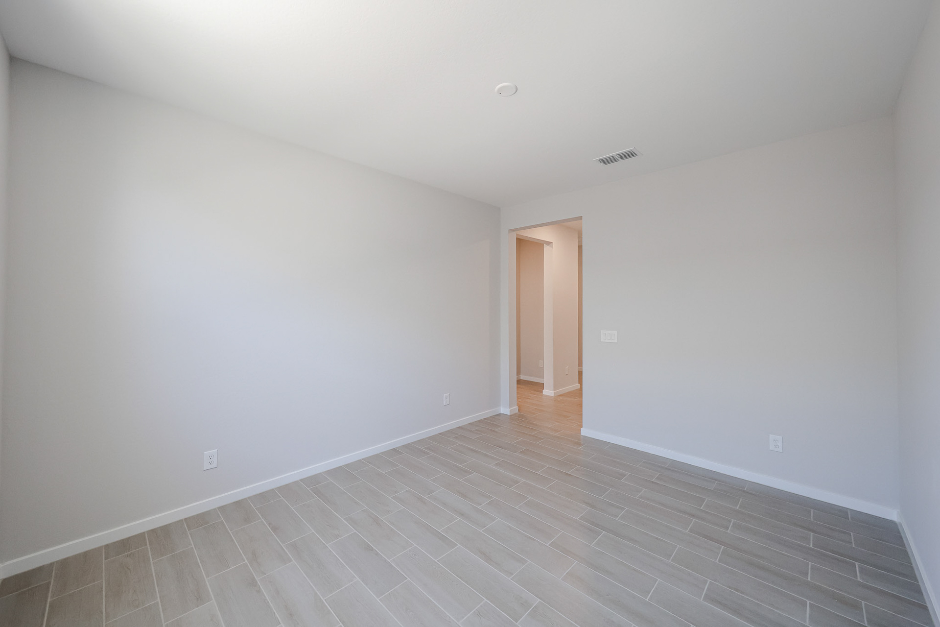 A hallway with white walls.