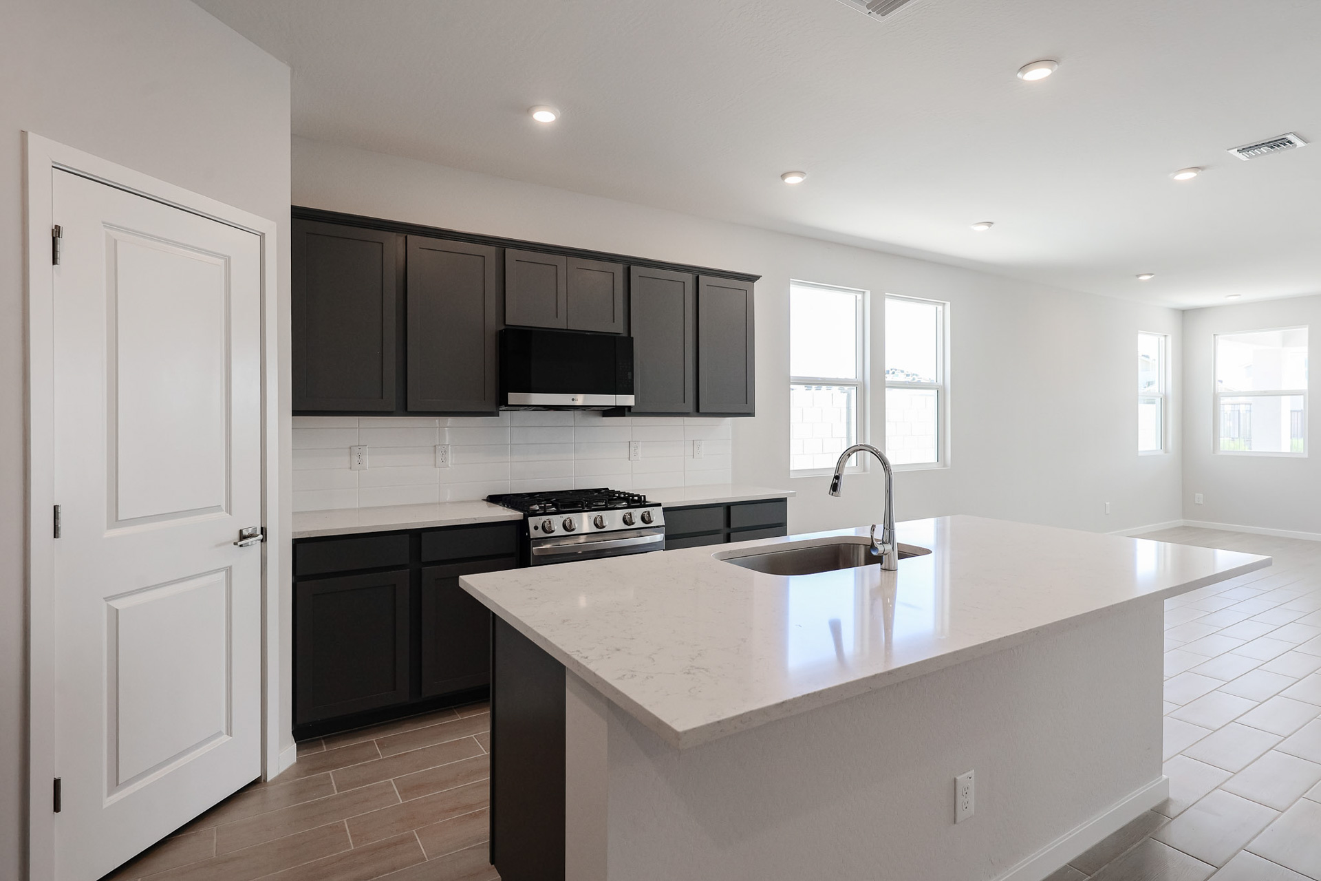 A kitchen with black cabinets.