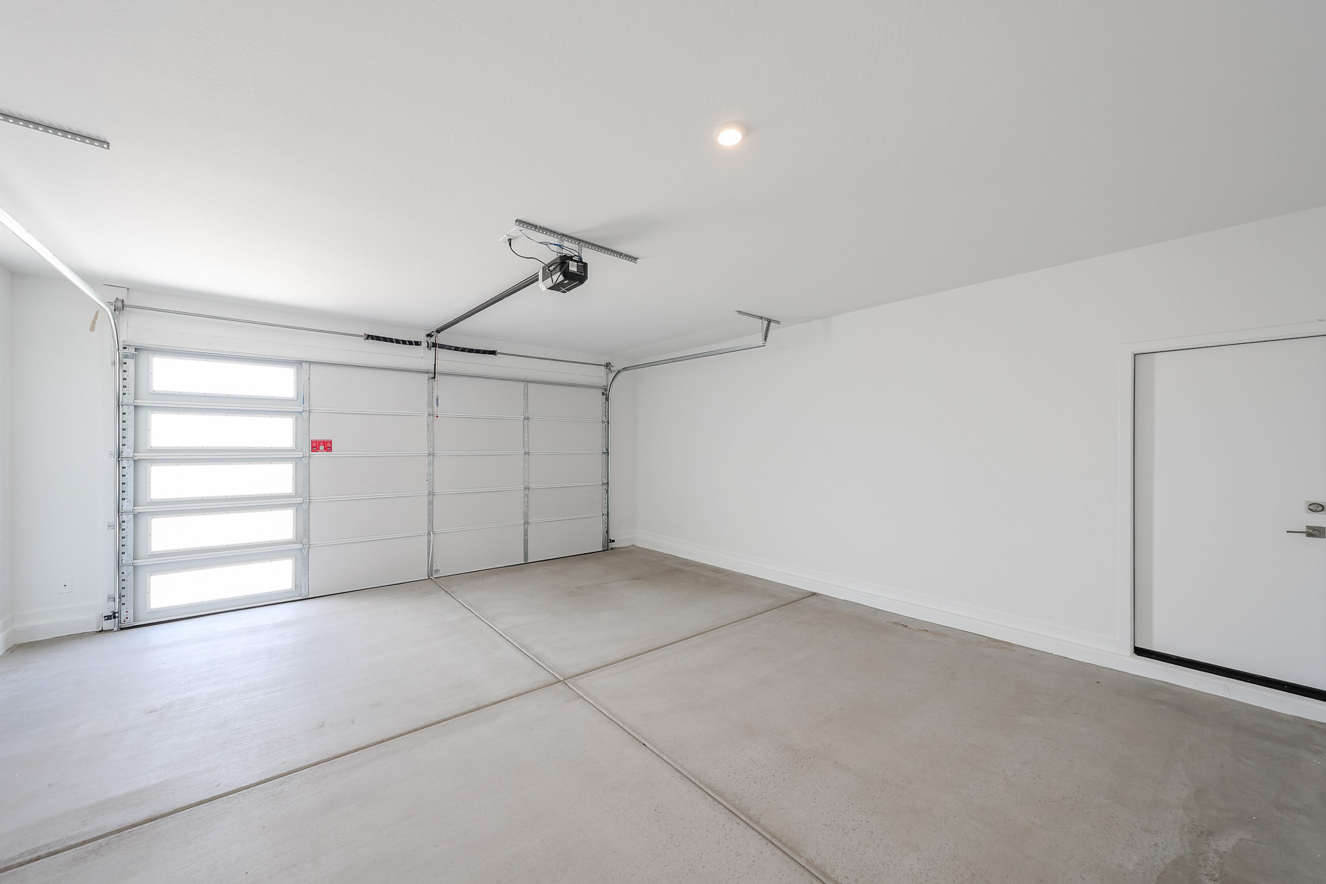 A room with white walls and a ceiling fan.