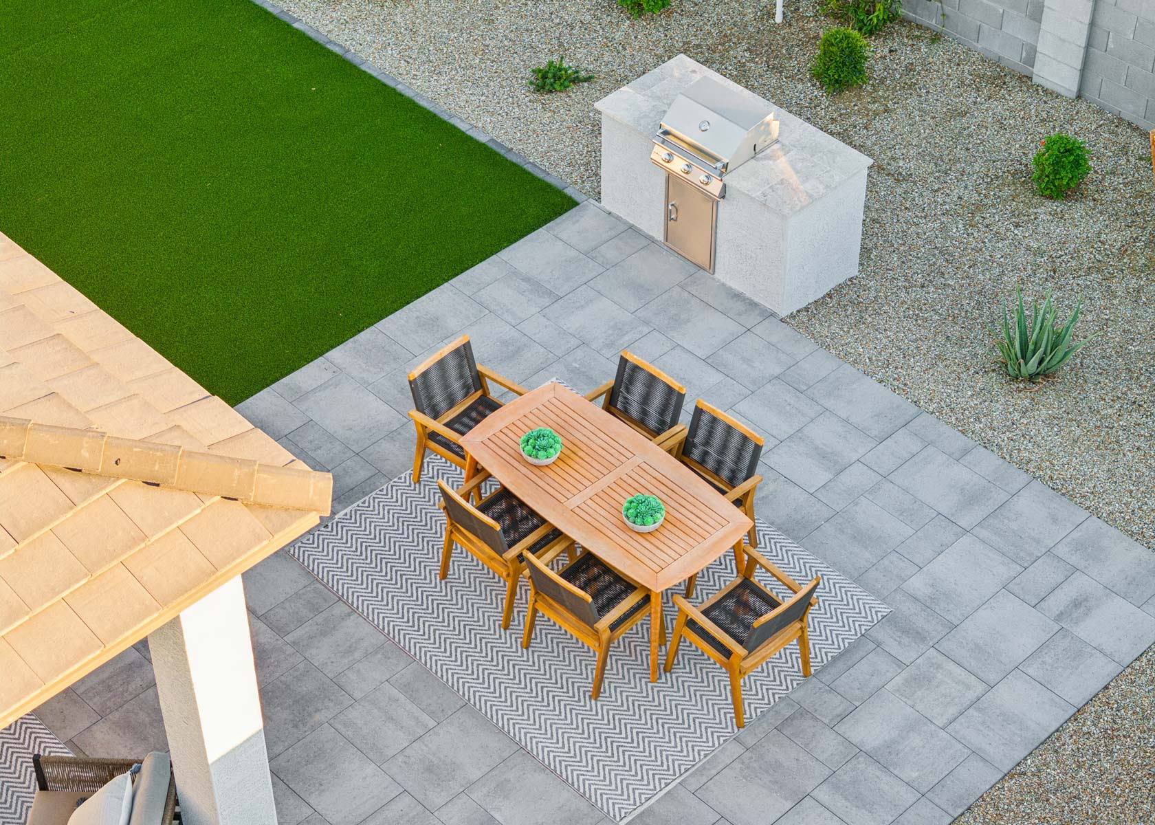 Arial drone photo of extended back patio, bbq, editorial lifestyle shot at the lakes at rancho el dorado model home in maricopa, AZ with close access to the 347.