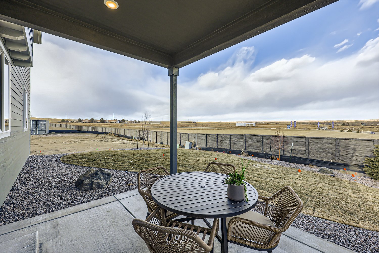 A patio with a table and chairs.