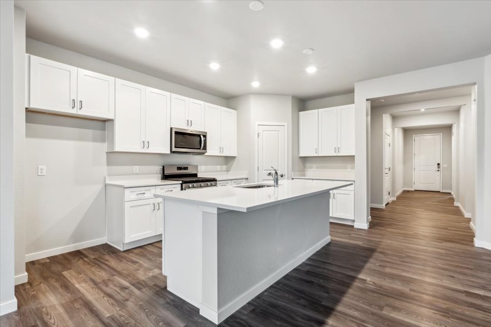 A kitchen with white cabinets.