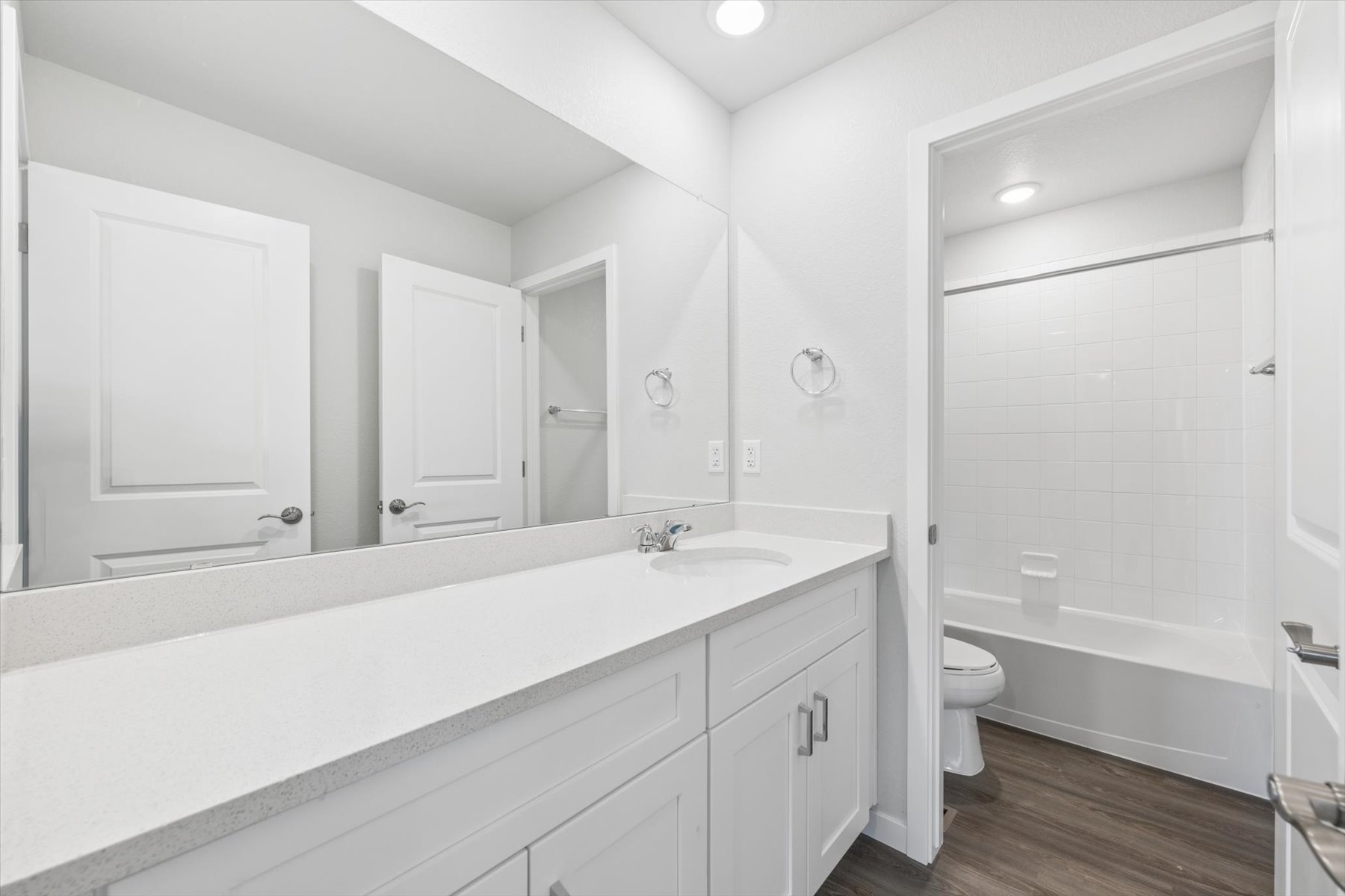 A bathroom with a tub sink and toilet.