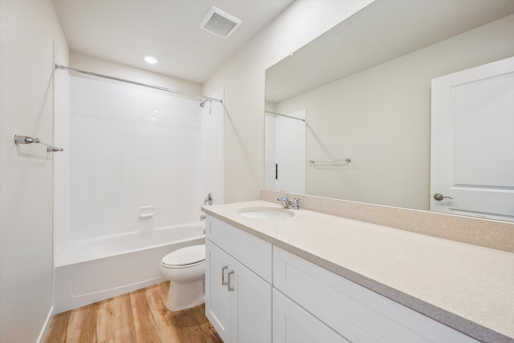 A bathroom with a tub sink and toilet.