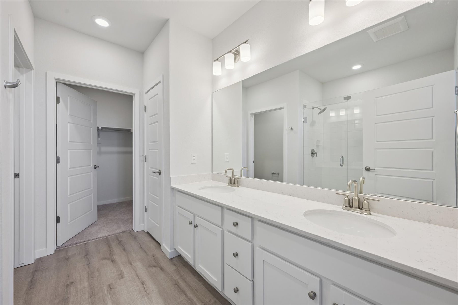 A bathroom with white cabinets.