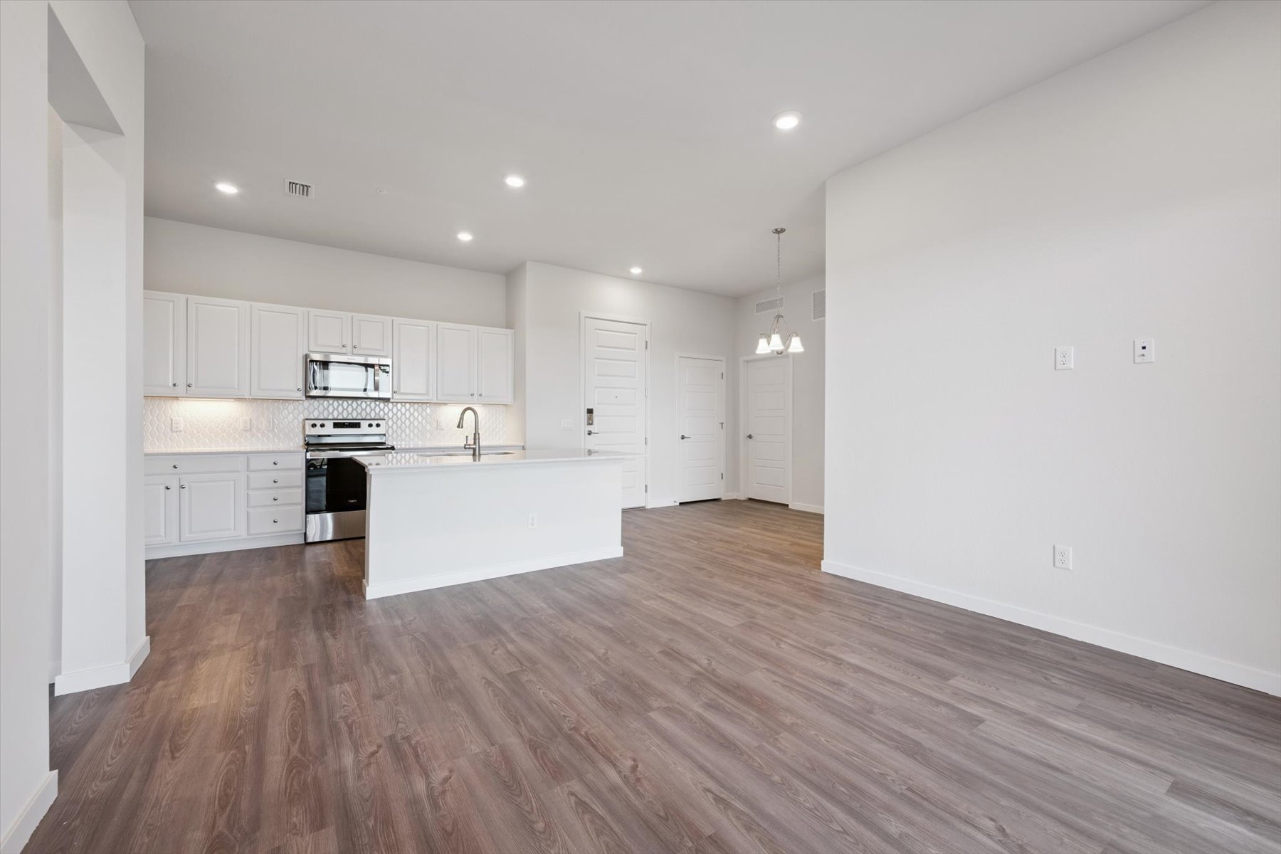 A kitchen with white cabinets.