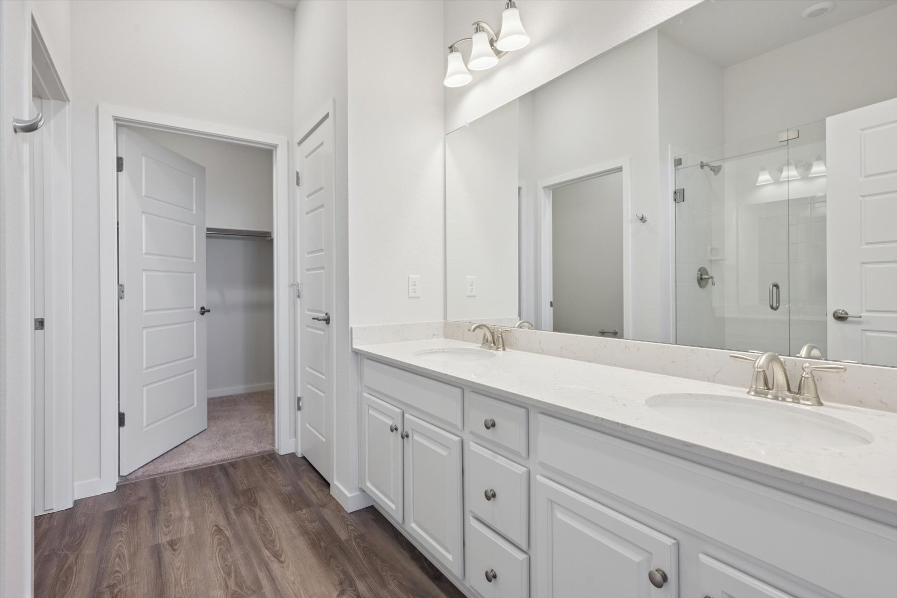 A bathroom with white cabinets.