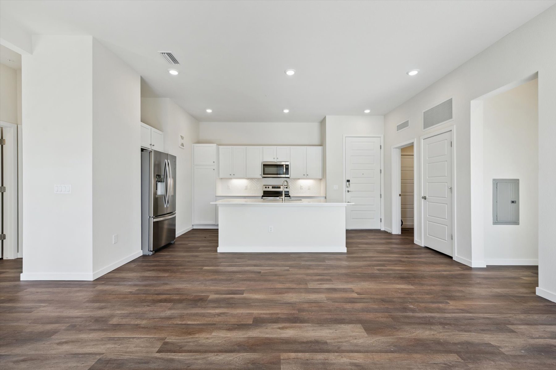 A large kitchen with white cabinets.