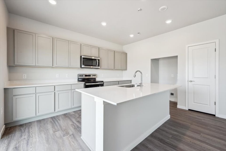 A kitchen with white cabinets.