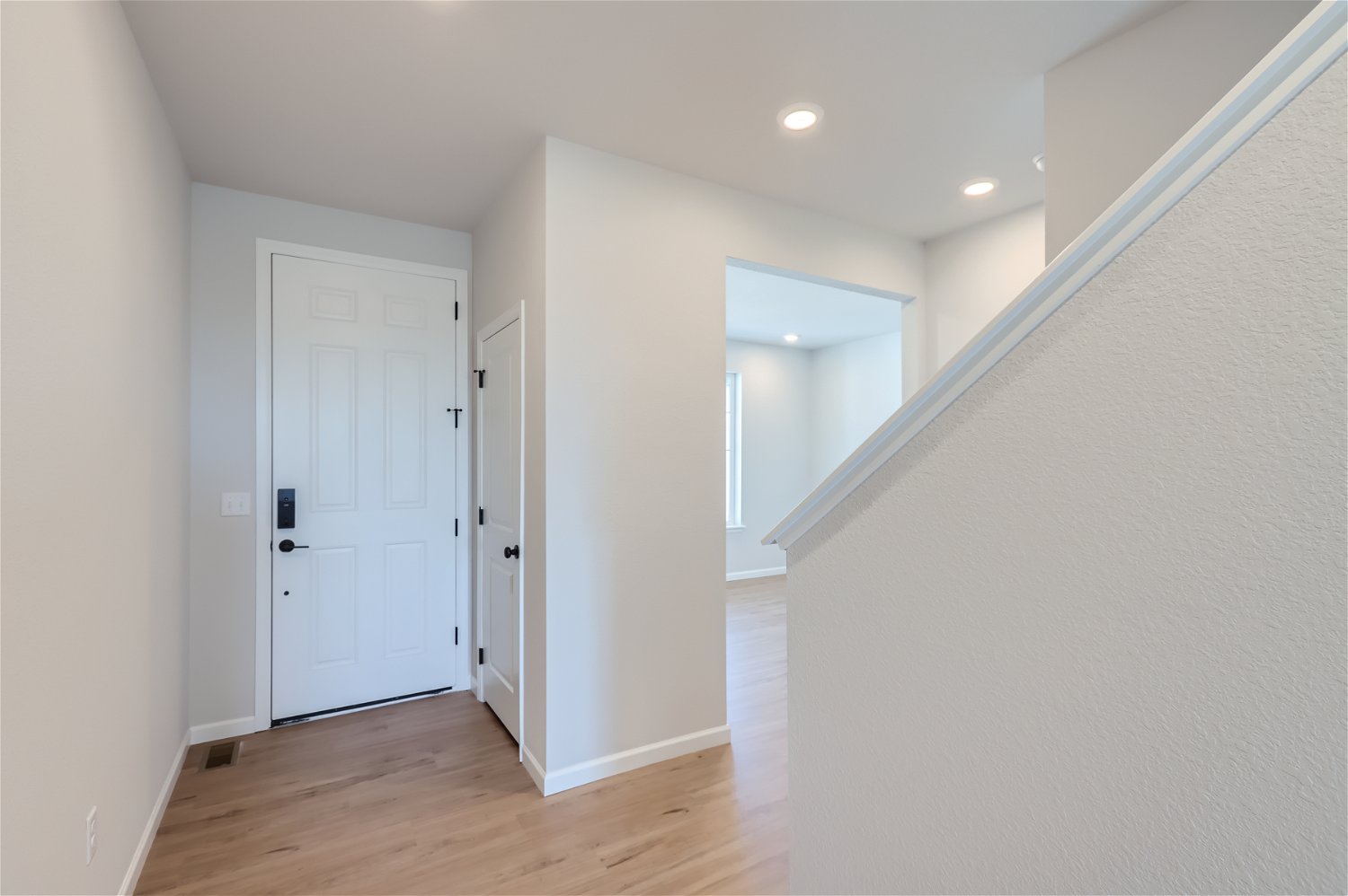 A hallway with white doors.