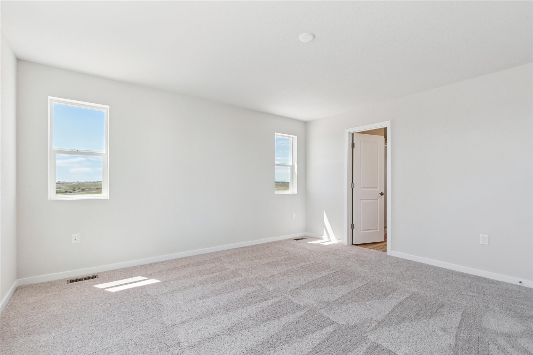 A room with a bed and a door.