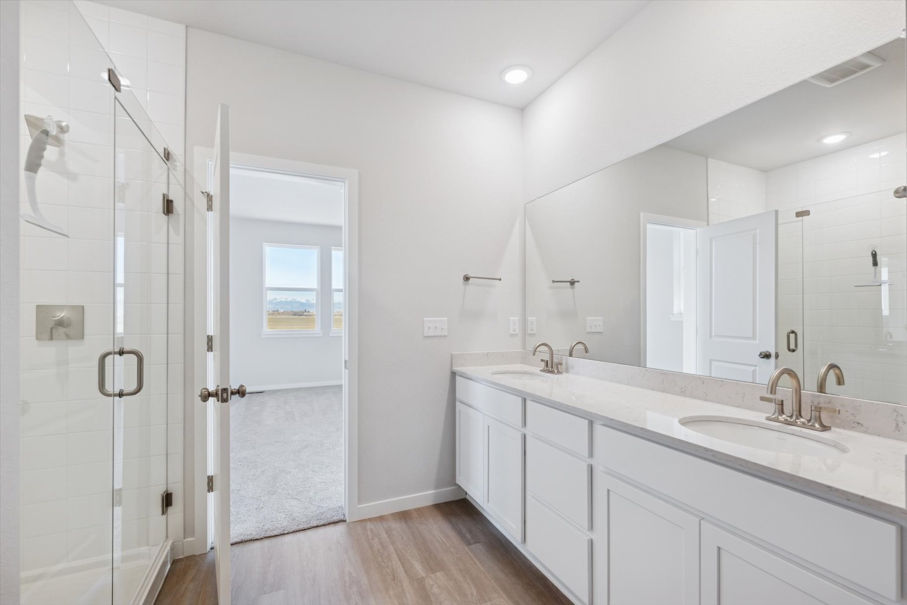 A bathroom with a sink and a shower unit.