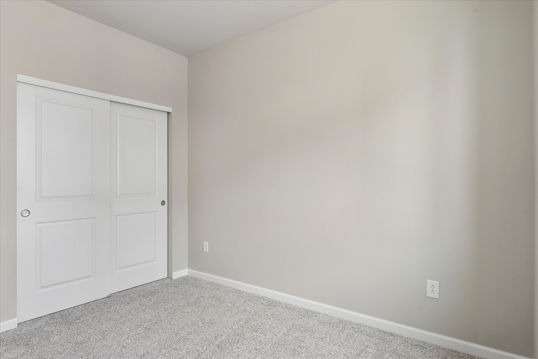 A white wall with a door.