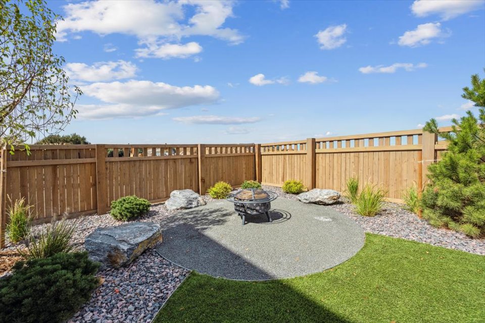 A fenced yard with a wheelbarrow and a wheelbarrow.