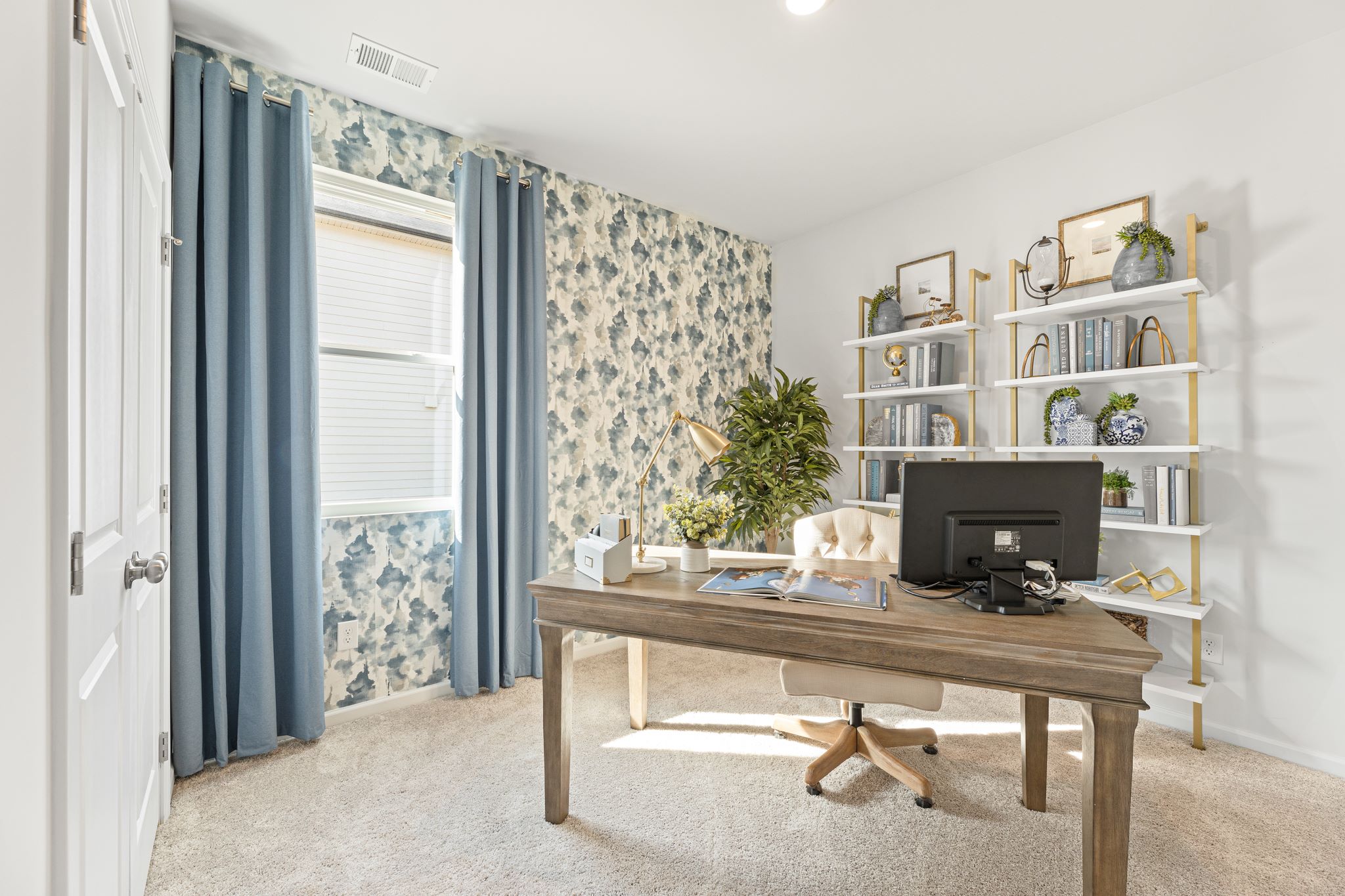 A room with a desk and a computer.