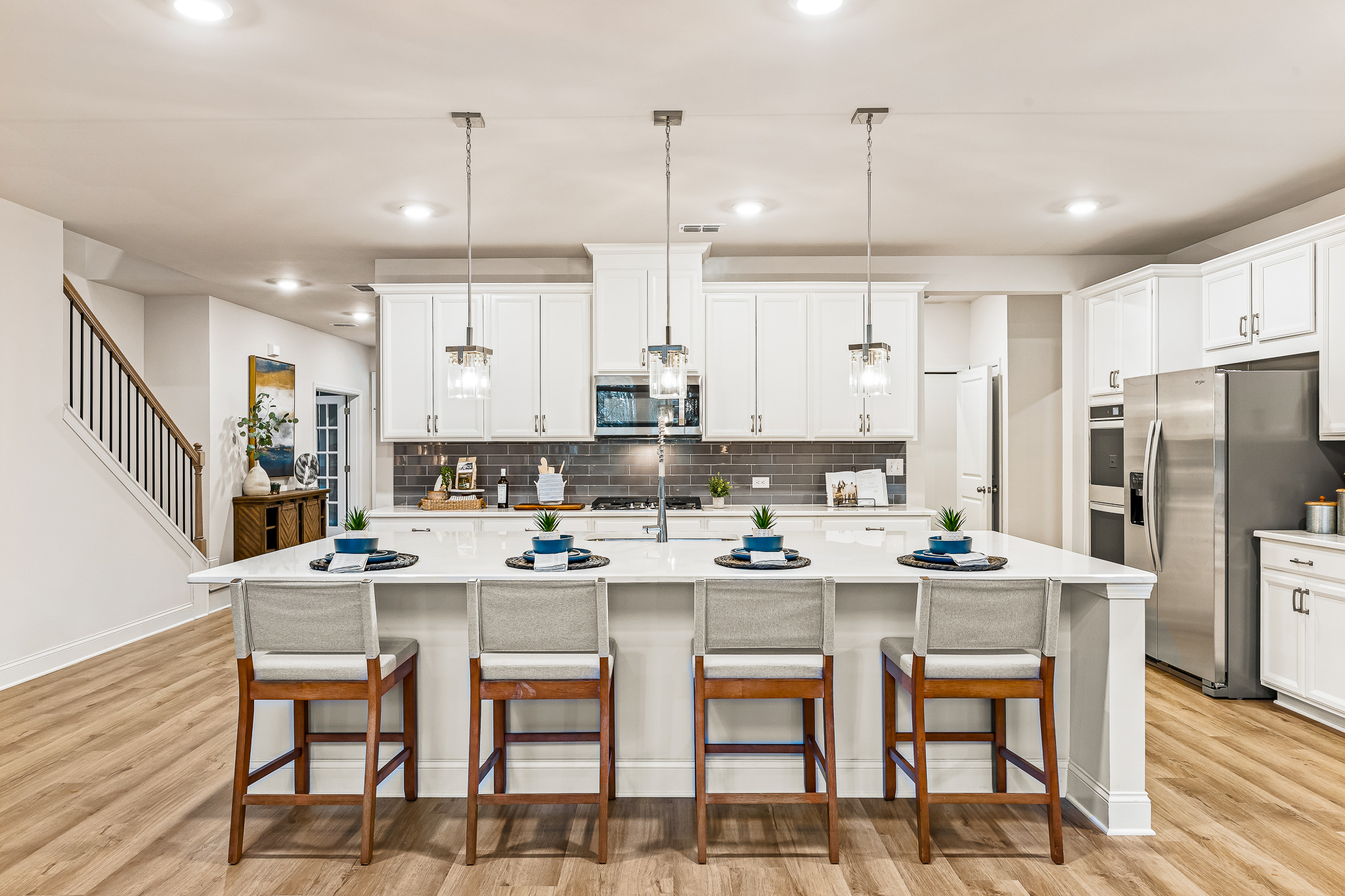 A kitchen with a dining table and a bar.