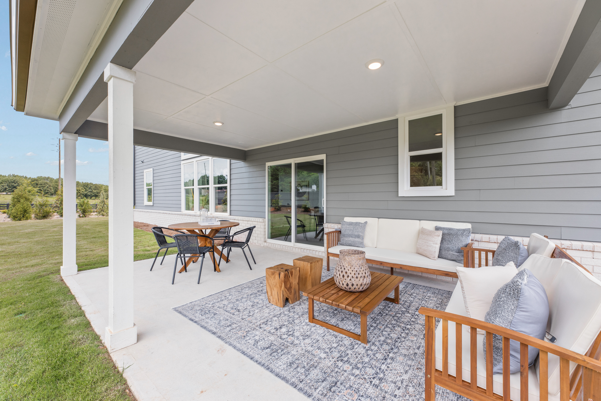 A patio with a table and chairs.