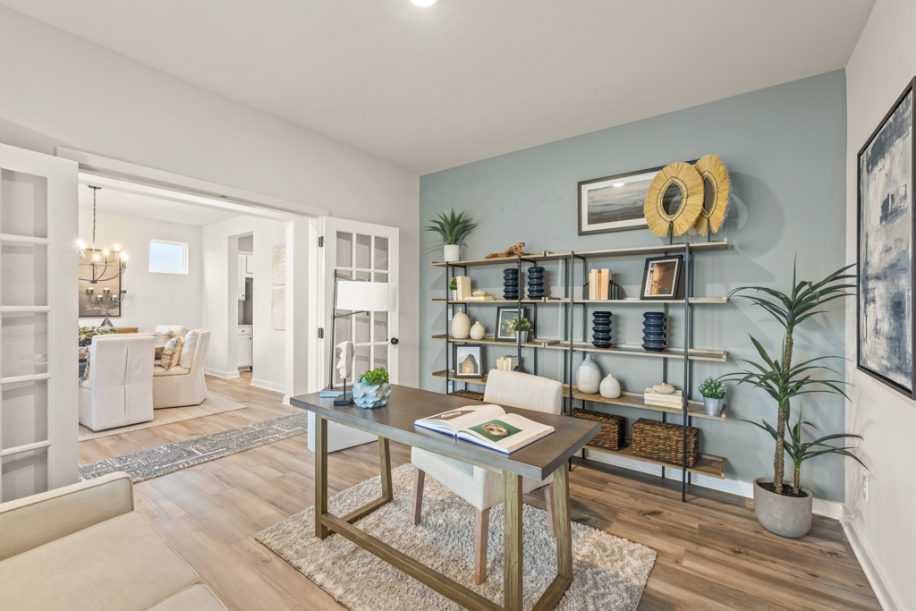 A living room with a table and chairs.