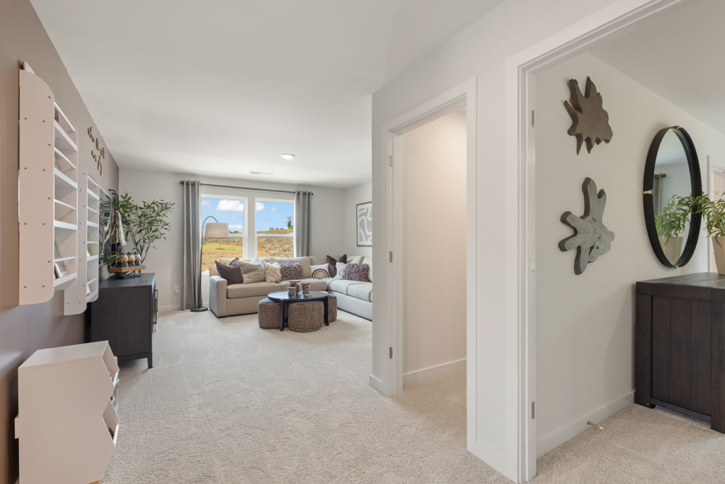 A living room with a couch and a mirror.