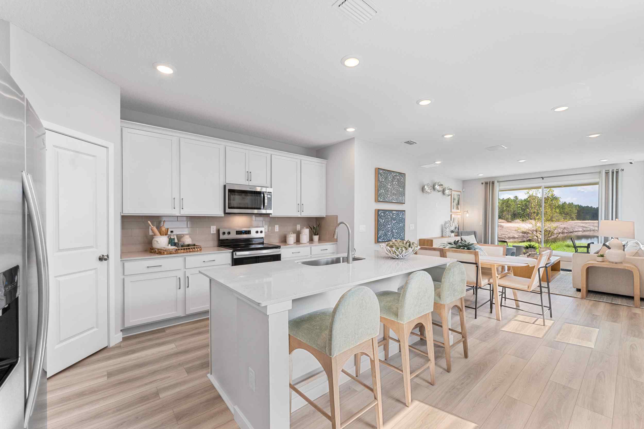 Laurel II Model Home Great Room with Kitchen and Living Room at Camden Woods in Kingsland, GA