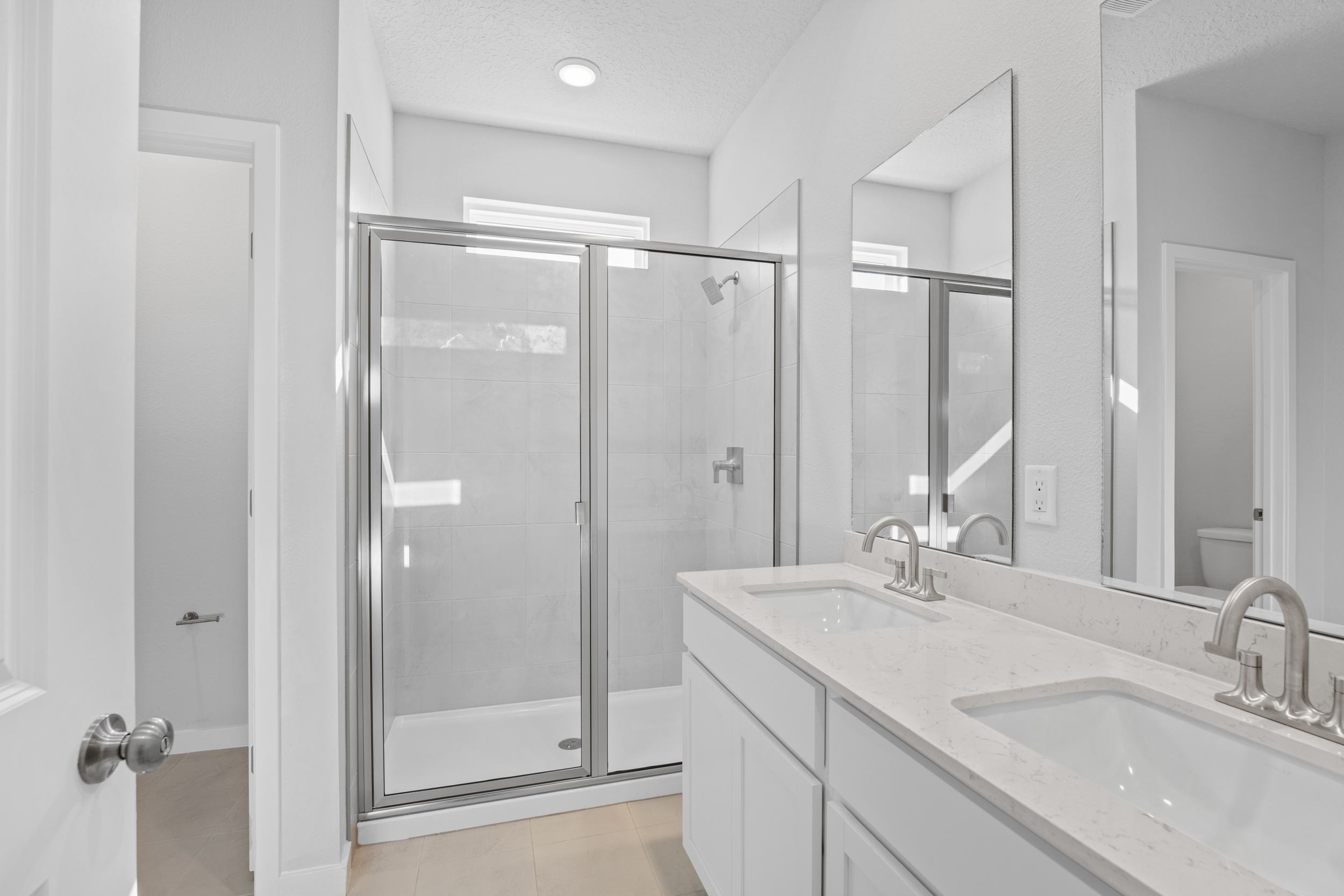 Lot 22 Primary Bath with Dual Vanity Sink and Walk-In Shower at Camden Woods in Kingsland